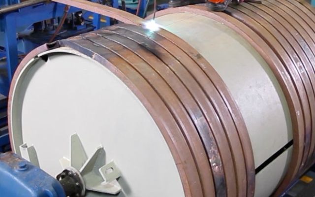 Copper coil being wound and welded on a mandrel